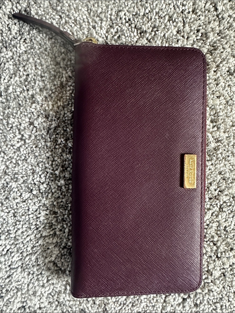 kate spade maroon zip-around leather wallet with gold logo plate